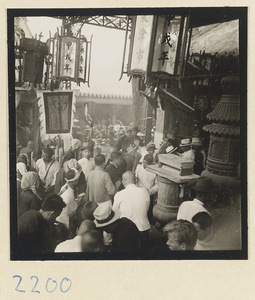 Pilgrims, lanterns, and incense burners under a canopy next to a temple on Miaofeng Mountain