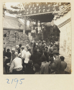 Pilgrims at a basin next to a brick incense burner on Miaofeng Mountain