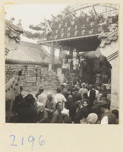 Pilgrims next to a brick incense burner on Miaofeng Mountain