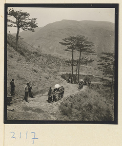 Pilgrim being carried up Miaofeng Mountain in a sedan chair