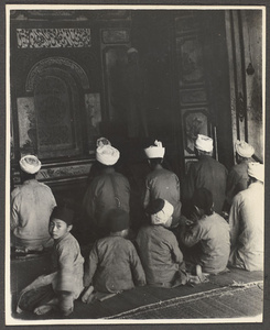 Men and boys praying in a mosque
