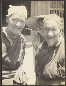 Two Muslim men and man with tobacco pipe