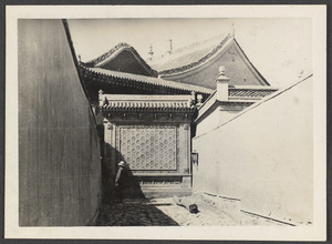 Sining.  China's Al Azhar.  Modern building 20 years old.  Mosque roof and entrance at end of lane after passing through gateway.