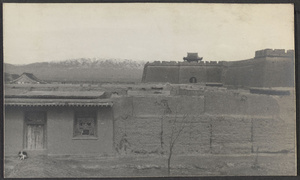 Yu Wang.  South Gate with snow-covered Lo Shan in background.  Our inn in foreground.