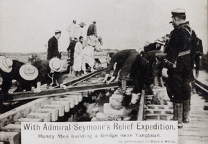 Sailors and Chinese workers repairing railway track on a bridge, Wuqing, during the Boxer Uprising