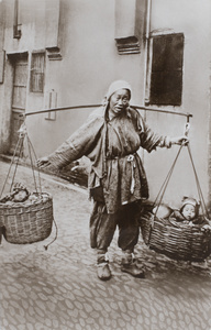 A woman beggar or refugee, with two babies in baskets