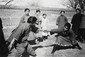 Two women playing a form of tug of war