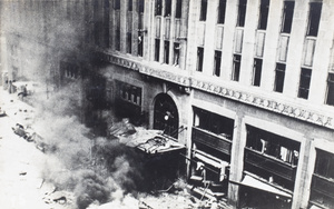 Debris burning outside the Palace Hotel, Nanking Road, Shanghai, after the bombing on 14 August 1937