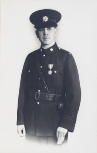 Studio portrait of John Montgomery in Shanghai Municipal Police uniform