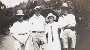 Three men and a woman on a hill track