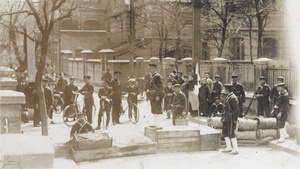Shanghai Municipal Police with Japanese marines and officers, and onlookers, at an improvised street barricade, Shanghai