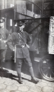 Chinese Shanghai Municipal Police with a man in a holding cage on a lorry