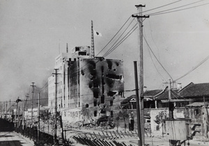 Japanese flag flying on Shanghai North Railway administration building, Boundary Road, Zhabei, 1937