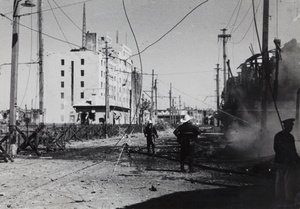 Fire fighters hosing down fires near Shanghai North Railway Administration Building, Boundary Road, Shanghai, 1937