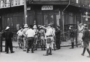 Shanghai Volunteer Corps, American, British and Chinese soldiers watching fire fighters, Shanghai, 12 September 1937