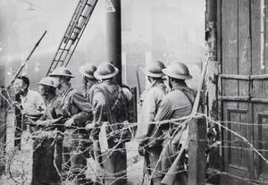 Chinese soldiers watching fire fighters, Shanghai, 12 September 1937