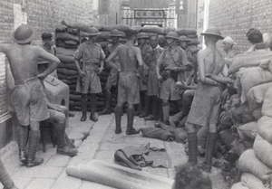 British soldiers in an alley barricaded with sandbags, Shanghai, 1937