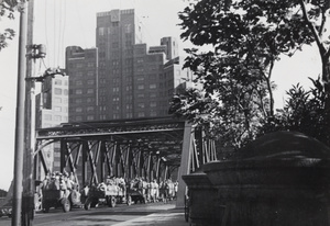 Convoy of Public Works Department labourers employed to clean up aftermath of bombing, Garden Bridge, Shanghai, 1937