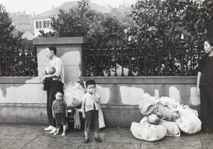 Women refugees with children and bundles of possessions, Shanghai, 1937