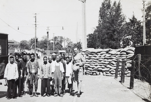 Shanghai Volunteer Corps soldiers with looters about to be expelled, near a check point, 1937