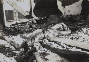A burnt corpse amid wreckage at Chusan Road, near Ward Road, Shanghai, October 1937