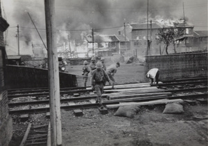 Japanese marines laying a level crossing, near Shanghai North Railway Station, Zhabei, October 1937