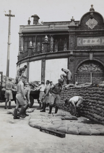British soliders building sandbagged guard post, North Honan Road and Range Road, Shanghai, October 1937