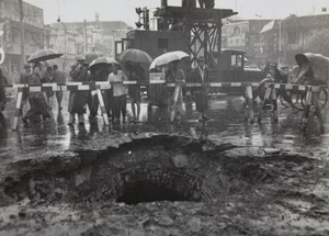 Onlookers at crater, Avenue Edward VII and Yu Ya Ching Road, Shanghai, caused by bomb dropped 14 August 1937