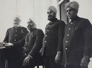 Four Chinese Maritime Customs Service men in an office, Shanghai