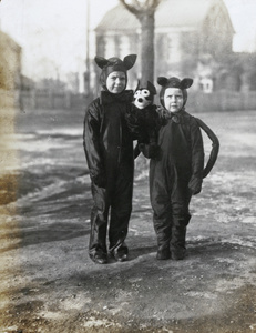 Gerald and Donald Johns wearing fancy dress, with a Felix the Cat toy