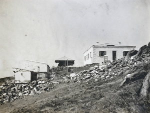 Damaged buildings near lighthouse