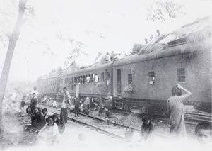 Train carriages with straw shelters, during the retreat from Guilin, 1944