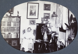 Leo Dudeney reading in the Kalee boarding house apartment, Shanghai