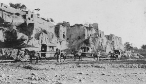 Palanquins on a road below yaodong dwellings