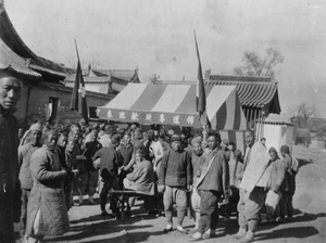 People gathered around a Baptist gospel preaching tent