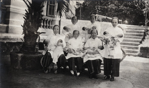 Nurses with newly born babies, outside a maternity hospital, Hong Kong