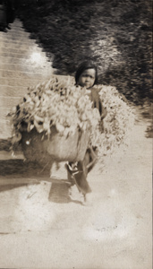 A child worker carrying two baskets