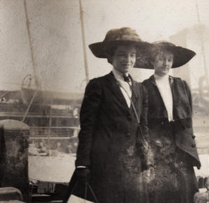 Two women in front of a ship, Hong Kong