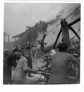 Damping down the smouldering ruins of buildings, Chongqing