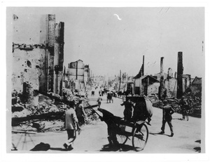 Rickshaws and pedestrians in a street of ruins, Chongqing