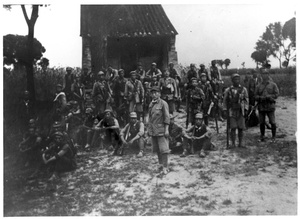 A group of soldiers in front of a building