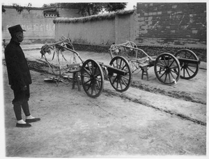 A soldier, with old artillery from early warlord civil wars, Central Hebei province, Spring 1938