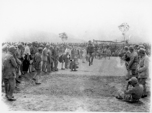 A foreigner being photographed doing a long jump (sport)