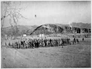 Soldiers gathered near sports pitches (basketball and football)