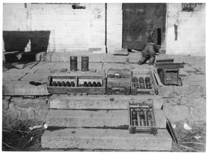 Erica Lindsay playing near a display of captured Japanese munitons, 2nd Sub-district, Qian Tan, Jinchaji