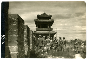 Chinese soldiers on a city wall near a gateway