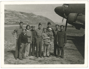 Hsiao Li Lindsay (李效黎) and baby Erica Lindsay, with others, beside a Douglas C-47 Skytrain (Dakota), after the arrival at Yan'an (延安) of the U.S. Army Observers Section, 1944