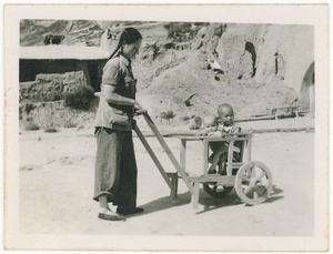 Hsiao Li Lindsay (李效黎) with Erica and James Lindsay in a homemade pram (stroller), Yan'an (延安)