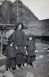 A smiling woman, with two children