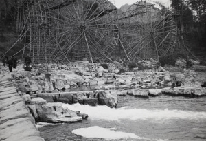 Waterwheels by a river